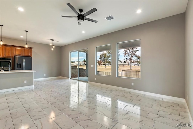 unfurnished living room with marble finish floor, baseboards, visible vents, and recessed lighting