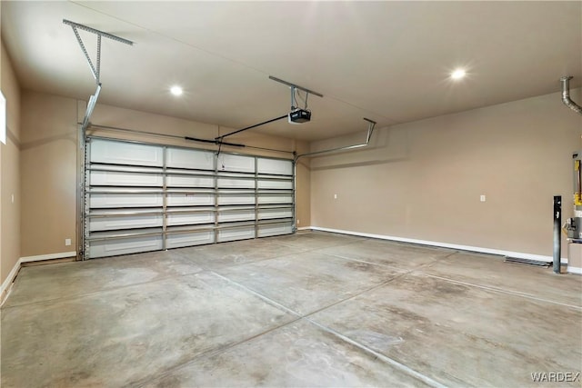 garage featuring recessed lighting, baseboards, and a garage door opener