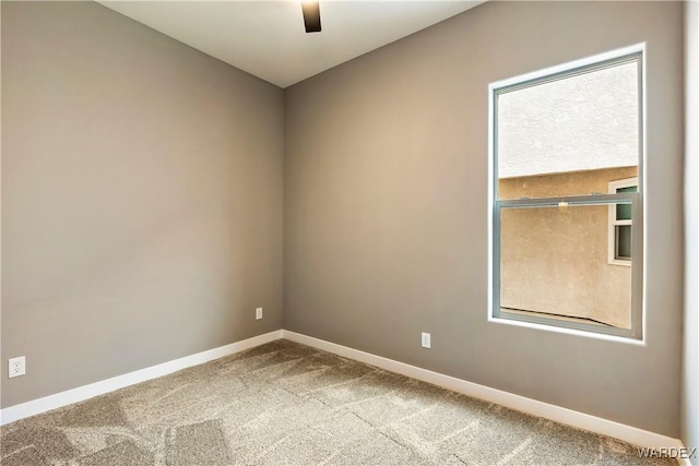 empty room with carpet and baseboards