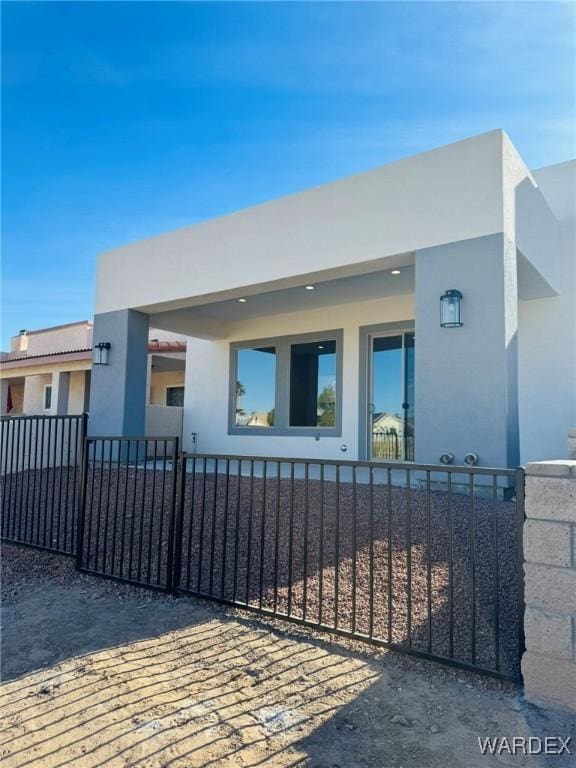 view of front of property with a fenced front yard and stucco siding