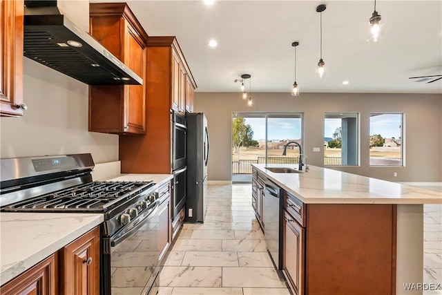 kitchen with pendant lighting, marble finish floor, stainless steel appliances, a sink, and wall chimney exhaust hood