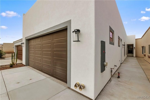 garage featuring concrete driveway