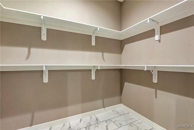 spacious closet with marble finish floor