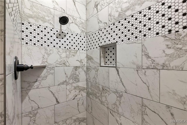 interior details with a tile shower