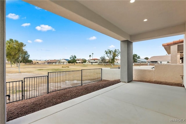 view of patio / terrace featuring fence and a residential view