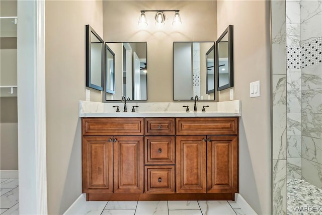 bathroom featuring marble finish floor, a sink, and a walk in shower