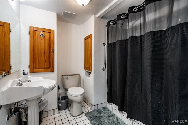 bathroom with toilet, curtained shower, visible vents, and tile patterned floors