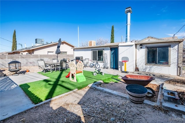 rear view of property with a patio, a yard, fence, and central air condition unit