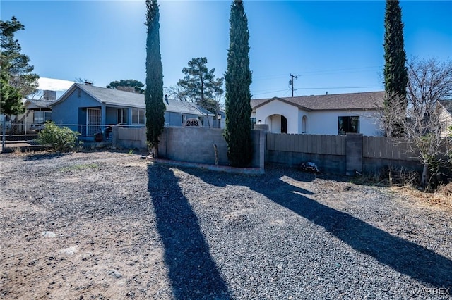 view of front of property with a fenced front yard and stucco siding