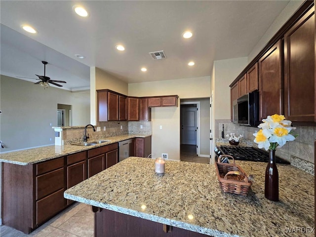 kitchen with visible vents, dishwasher, a peninsula, light stone countertops, and a sink