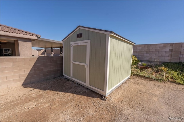 view of shed featuring fence