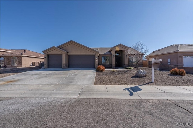 view of front of home featuring a garage, concrete driveway, and stucco siding