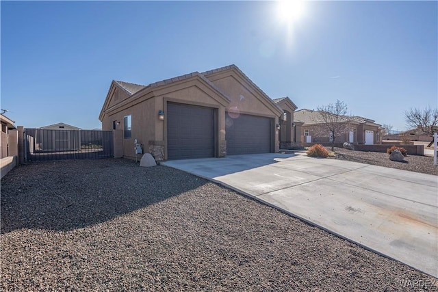 ranch-style home featuring driveway, a garage, fence, and stucco siding