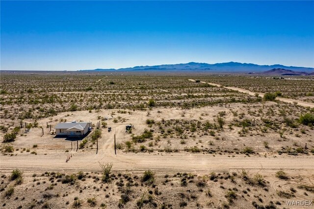 birds eye view of property with view of desert and a mountain view