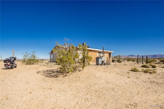 rear view of property featuring a rural view and a mountain view