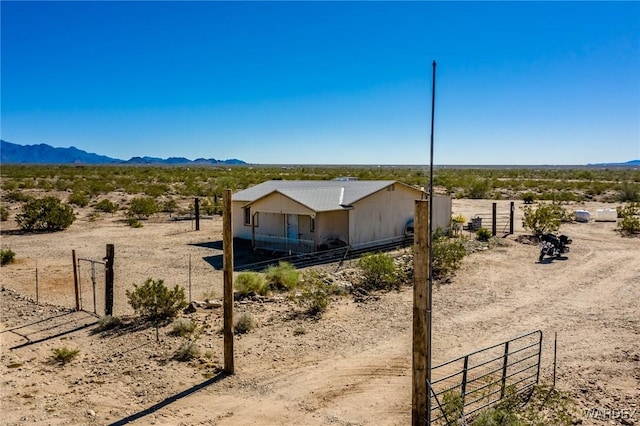 view of yard featuring fence and a mountain view