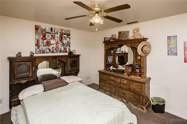 bedroom featuring carpet floors, visible vents, baseboards, and a ceiling fan