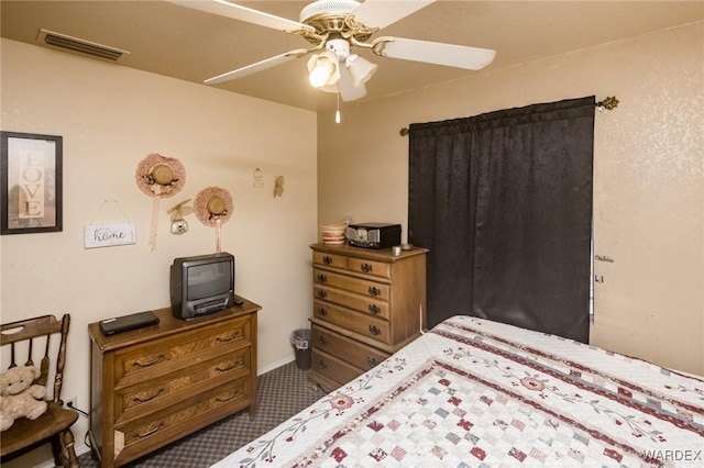 bedroom with dark colored carpet, visible vents, and ceiling fan