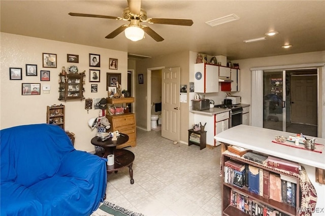 interior space featuring a ceiling fan, visible vents, and light floors