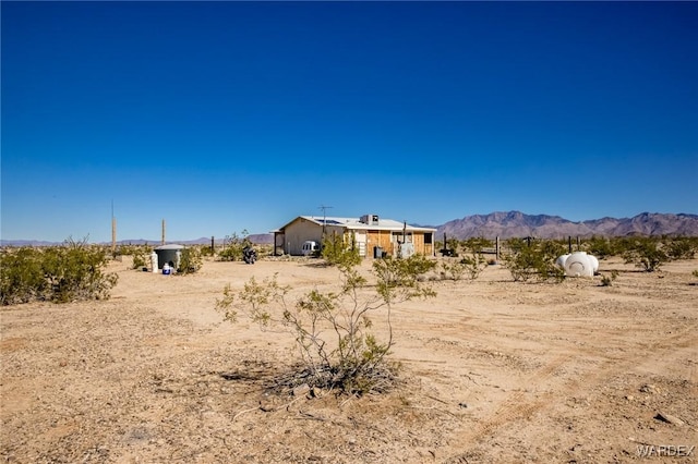 view of yard with a rural view and a mountain view