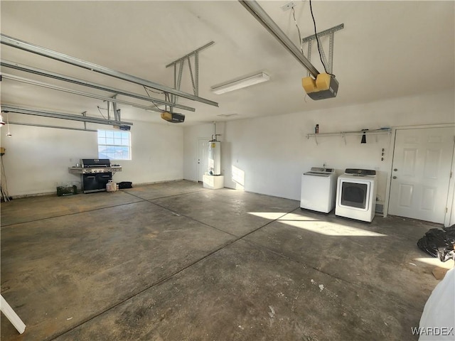 garage featuring water heater, separate washer and dryer, and a garage door opener