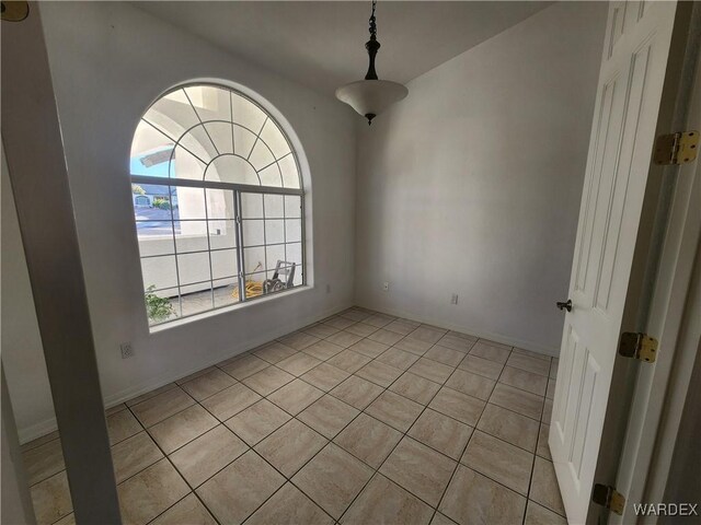 empty room with light tile patterned floors