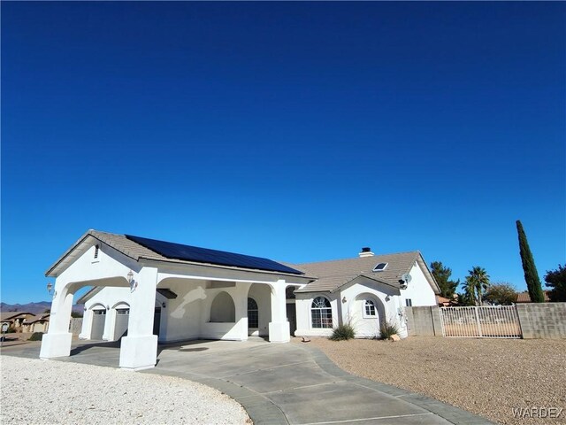 view of front of home featuring a tile roof, fence, and stucco siding