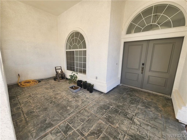 doorway to property with stucco siding