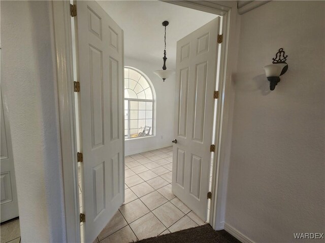 corridor with light tile patterned flooring