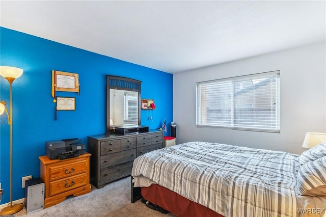 bedroom featuring light carpet