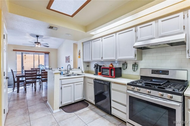 kitchen featuring light countertops, a sink, stainless steel gas range, dishwasher, and under cabinet range hood