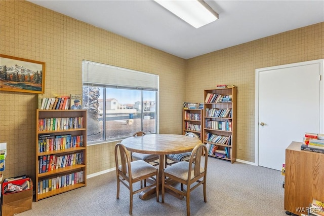 dining area featuring light carpet and wallpapered walls