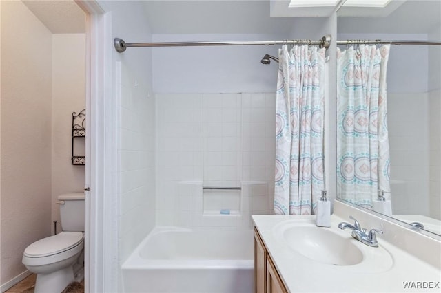 bathroom with toilet, shower / bath combo, and vanity