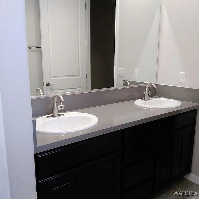 full bathroom featuring double vanity and a sink