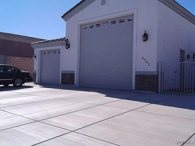 exterior space featuring driveway and stucco siding