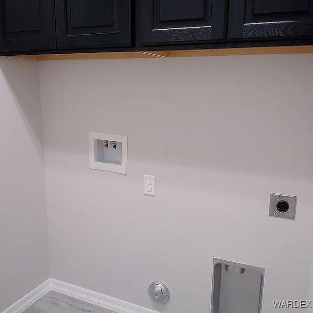 laundry room featuring cabinet space, baseboards, gas dryer hookup, hookup for a washing machine, and hookup for an electric dryer