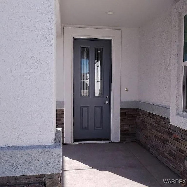 doorway to property with stucco siding