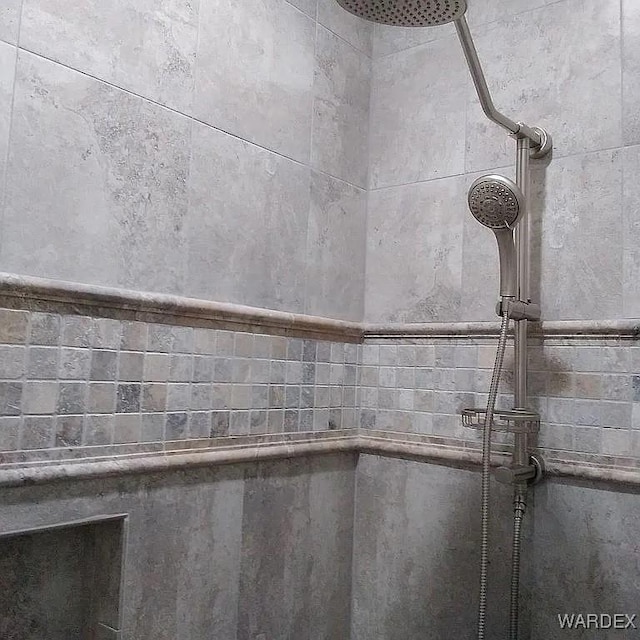 interior details with a tile shower