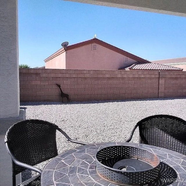 view of patio featuring fence