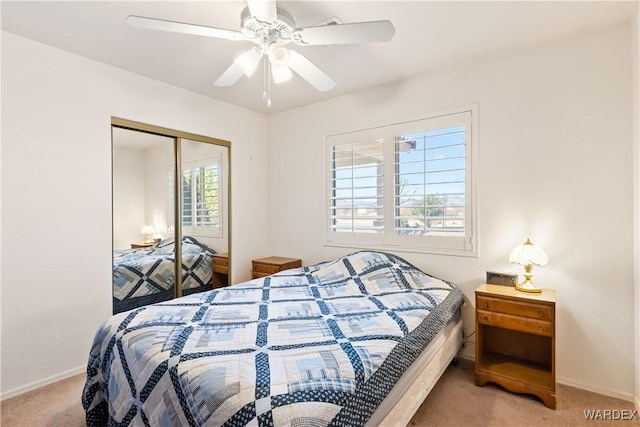 bedroom with carpet floors, a closet, a ceiling fan, and baseboards