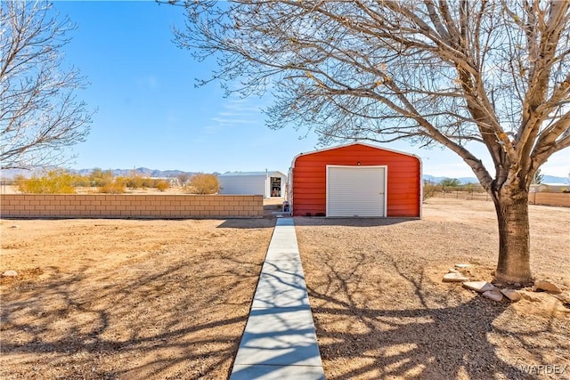 view of outbuilding with fence and an outdoor structure