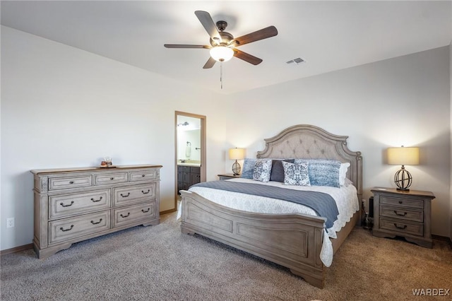 bedroom featuring visible vents, baseboards, a ceiling fan, ensuite bath, and carpet