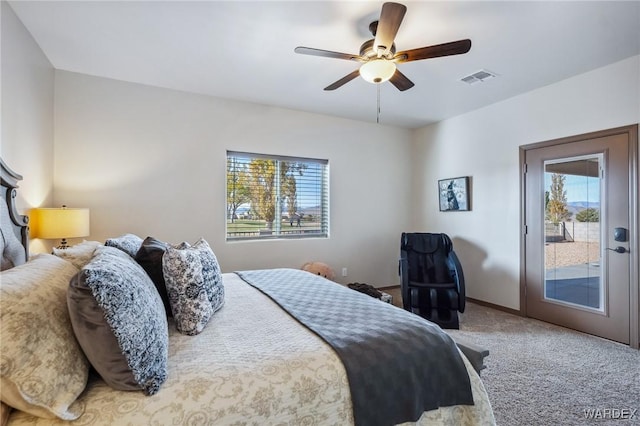 bedroom featuring carpet floors, multiple windows, visible vents, and a ceiling fan