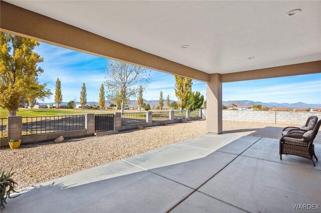 view of patio / terrace with a fenced backyard and a mountain view