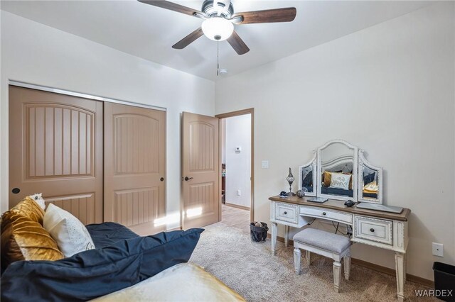 bedroom with a closet, carpet flooring, a ceiling fan, and baseboards