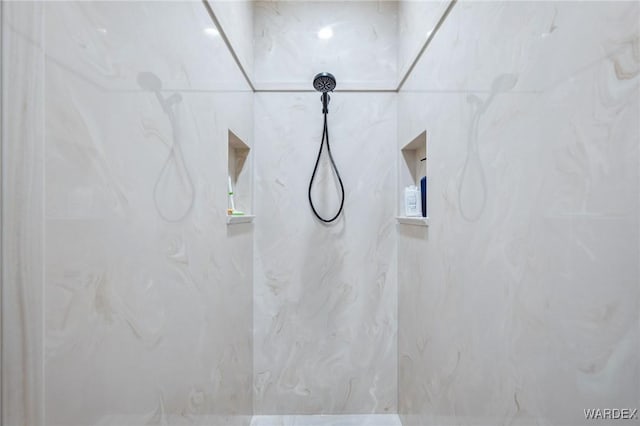 bathroom with a marble finish shower