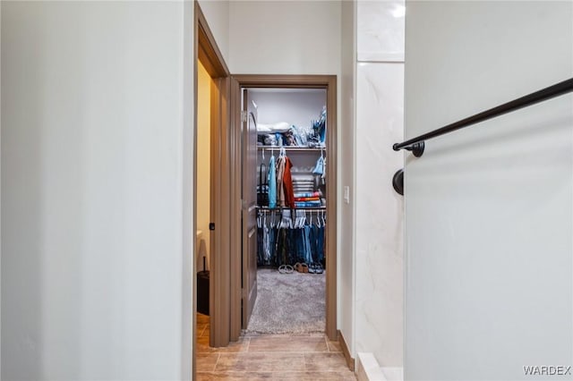 hallway featuring light colored carpet