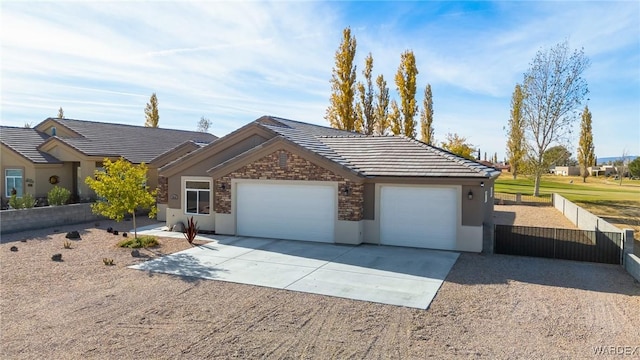 single story home with a garage, driveway, stone siding, a tile roof, and stucco siding