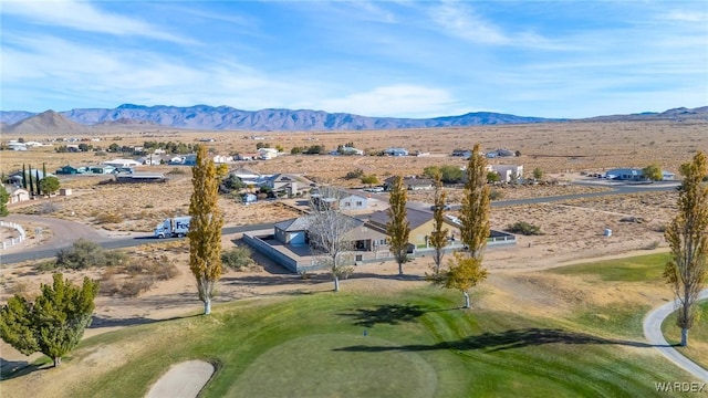 aerial view with view of golf course and a mountain view