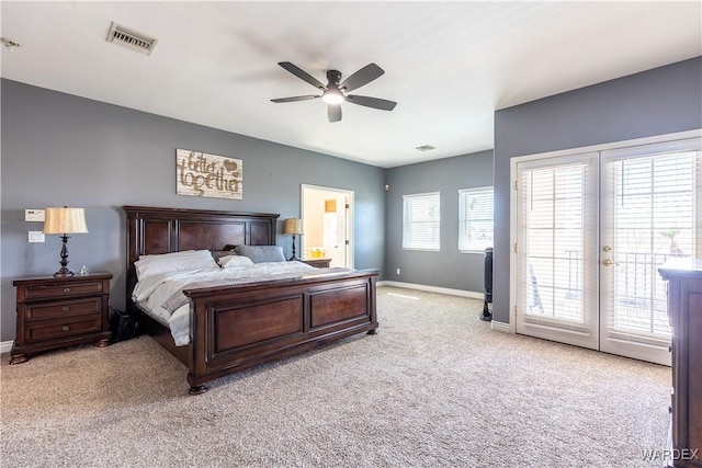 bedroom featuring french doors, light colored carpet, visible vents, access to outside, and baseboards